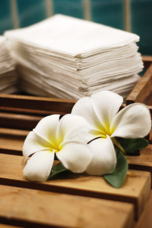 Frangipani flower with stack of white towelの写真素材
