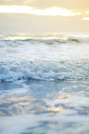 Ocean wave on a sandy beach in the morning