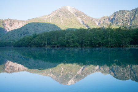 Early morning at spring Kamikochi Taisho-ike pond,nagano,japanの写真素材
