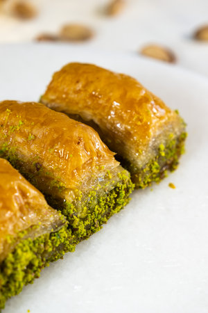 Pistachio baklava on white marble. Traditional middle eastern dessert. Turkish Antep baklava.の写真素材