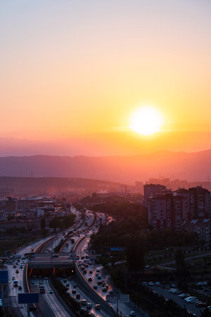 Vehicle traffic at sunset. City streets, buildings and cars.の写真素材