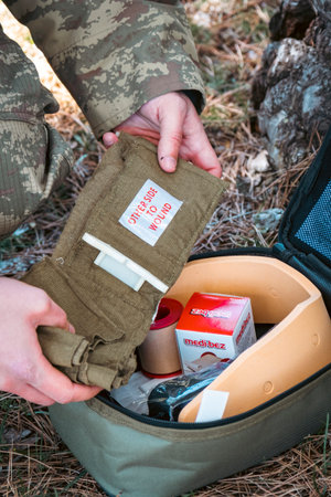 Military army first aid kit. Camouflaged soldier medic.のeditorial素材