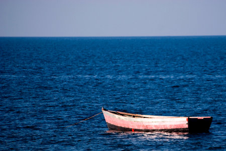 Lonely, Old Boat Floating on the Lake, Malawiの写真素材