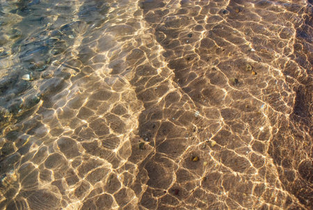 Sun Shining on Shallow Water on the Beach of Lake Tanganyika, Tanzania, Africaの写真素材