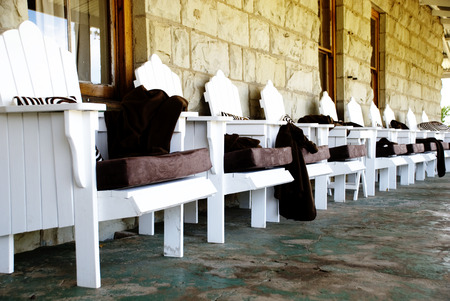 Line of Cozy White Chairs on the Veranda of a Rural Guest Houseのeditorial素材
