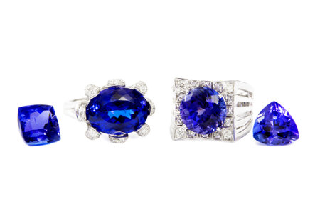 Two Different Ladies Rings with Tanzanite and Diamonds and two Tanzanite Stones, Designer Jewellery, Isolated on White Backgroundの写真素材
