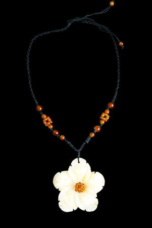 Necklace with Flower and Orange Beads, on Black String, Isolated on Black Backgroundの写真素材