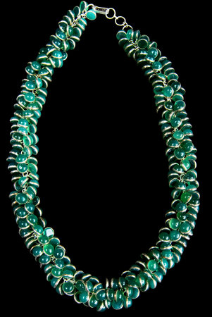 Necklace with Green Gemstones and Gold, Isolated on Black Backgroundの写真素材