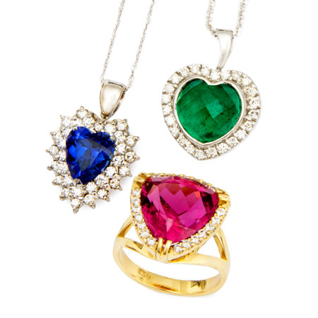 Combination of Three Jewellery Pieces: Heart Shaped Sapphire and Diamond Pendent, Heart Shaped Emerald and Diamond Pendent, and a Ruby and Diamond Ring, Isolated on White Backgroundの写真素材