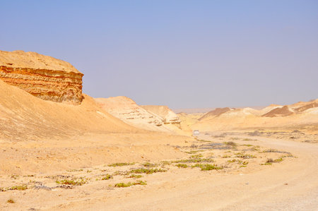 Vehicle Disappearing into the Distance of a Desert in Angola, Southern Africaの写真素材