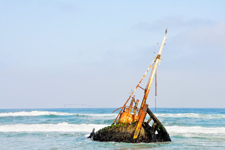 Rusted Old Shipwreck in the the Shallow Waters off the Coast of Angola, Southern Africaの写真素材