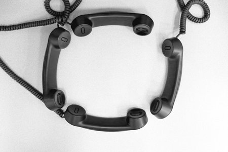 Telephone headsets arranged in a conference call themeの写真素材