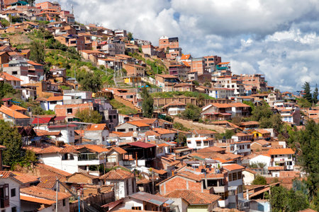 Red roofs houses on the hills in the historic capital of the Inca Empire, Cusco, Peruの写真素材