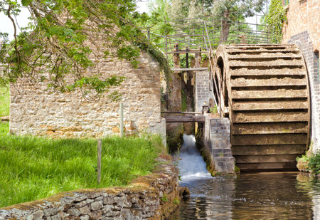 Old water mill in English villageの写真素材
