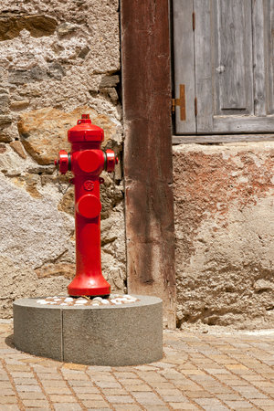 Red fire hydrant on a stone street