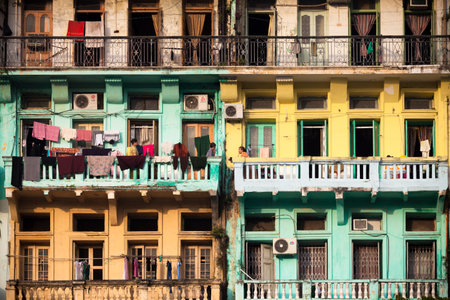 YANGON, MYANMAR - NOVEMBER 21, 2014 - Chit-chatting at the balcony located at the old neighbourhood...