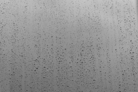 grey glass with raindrops backgroundの写真素材