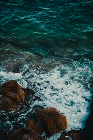 The sea, the foam  and rocks, view from above