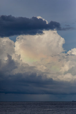 Rainbow clouds seascape. Beautiful colored sky. Unusual ocean weather.の写真素材