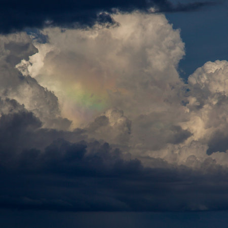 Rainbow clouds seascape. Beautiful colored sky. Unusual ocean weather.の写真素材
