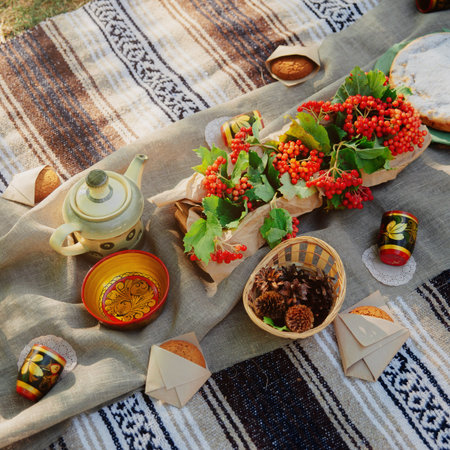 Summer picnic outdoor. Bright and colorful hipster lunch in the park. Female hands cut a piece of pieの写真素材