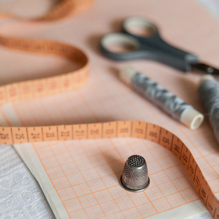 Sewing hobby background. Tailor's tools on white tableの写真素材