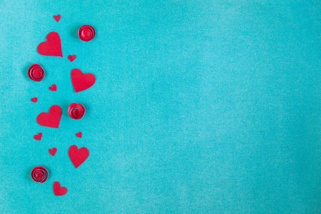 Overhead flat lay valentine day background. Red paper hearts and flowers handmade, kraft envelope...