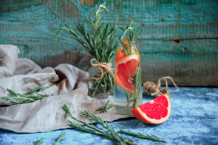 Infused water recipe. Grapefruit and rosemary detox water. Healthy lifestyle concept. Healthy habit of hydration.の写真素材