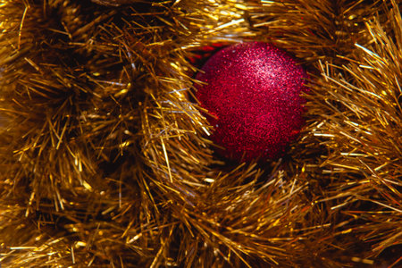Minimalist Christmas decorations in two colors: red and gold balls with shiny yellow tinsel. New year background.の写真素材