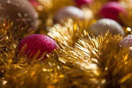 Minimalist Christmas decorations in two colors: red and gold balls with shiny yellow tinsel. New year background.の写真素材