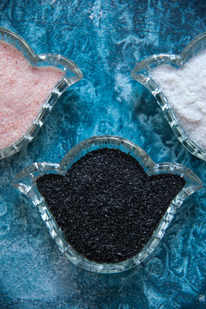 Flat lay still life of three different colors of salt: pink, black and white.の写真素材