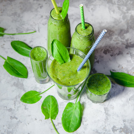 Still life of green smoothie in glass on white textured background. Healthy lifestyle conceptの写真素材