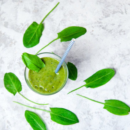 Still life of green smoothie in glass on white textured background. Healthy lifestyle conceptの写真素材