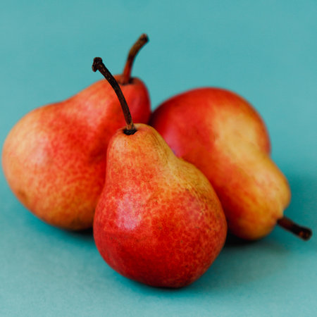 Three bright red williams pears on turquoise backgroundの写真素材