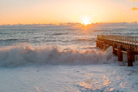 Yellow sun lights big storm waves. Sunset on the sea. Beautiful nature.の写真素材
