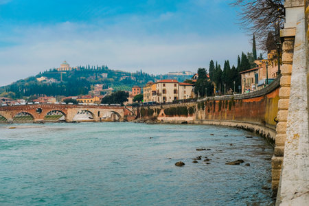 Roman arch bridge over Adige River in Verona. Historical center of European city. Romantic sightseeng trip to Italyの写真素材