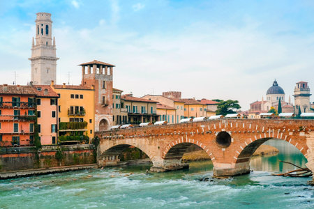 Roman arch bridge over Adige River in Verona. Historical center of European city. Romantic sightseeng trip to Italyの写真素材