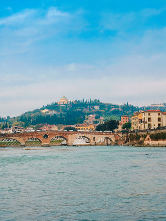 Roman arch bridge over Adige River in Verona. Historical center of European city. Romantic sightseeng trip to Italyの写真素材