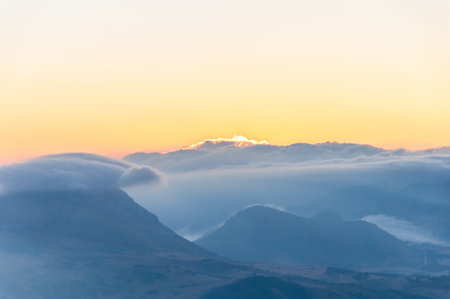 Sunrise with fog in mountainsの写真素材