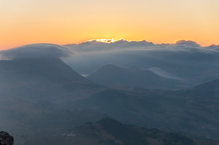 sun rising above the cloudsの写真素材