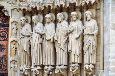 sculptures and reliefs at the entrance to the cathedral of Notre Dame in Parisの写真素材