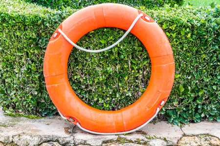 orange lifebuoy on wall
