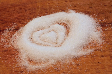 Heap of white and dark sugar with signs of heartsの写真素材