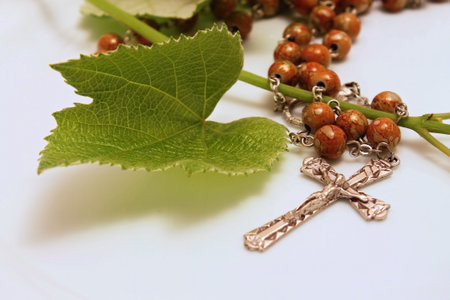 Rosary with crucifix on the white board の写真素材