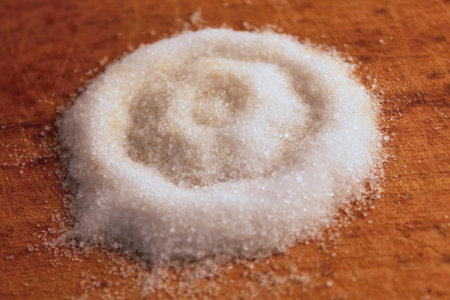 Heap of white and dark sugar with signs of bloomの写真素材