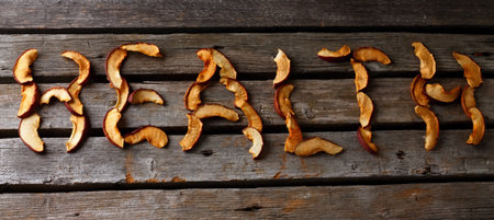 Horizontal photo with old worn grey wooden board and with lettering health which is made from dried...