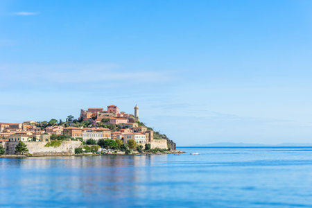 Horizontal photo of ancient part of Porto Ferraio, capital of Elba island in Mediterranean sea. The lighthouse and other buildings are behind few boats. Tilt-shift is used.の写真素材