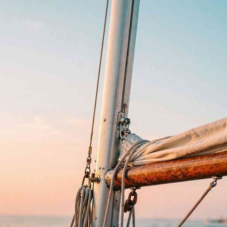 Detail of the rigging of a sailboat on the sea.