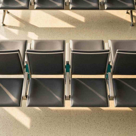 Empty chairs in airport terminal waiting area for departure or arrival of flight