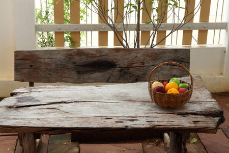 Variety of fruits into basket on old wood floorの写真素材